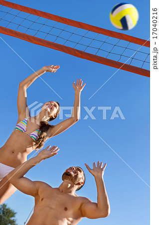 Smiling Beautiful couple playing volleyball Smiling Beautiful couple playing volleyball 17040216