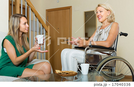 Handicapped woman with guest at the table Handicapped woman with guest at the table 17040336