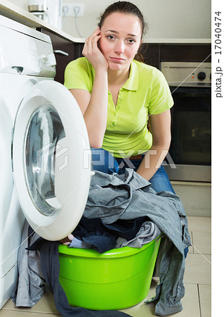Housewife standing near washing machine Housewife standing near washing machine 17040474