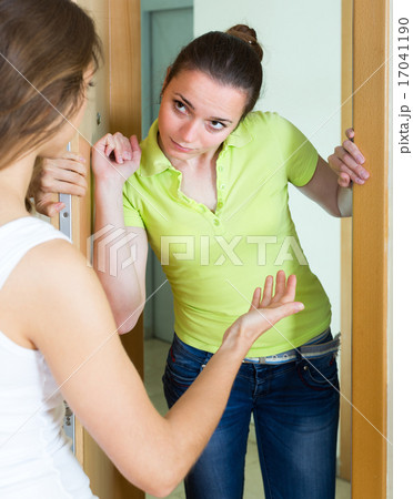 Young women having conflict at the door. Young women having conflict at the door. 17041190