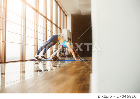 Mother and daughter stretching back in the gym Mother and daughter stretching back in the gym 17046816