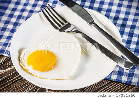 heart-shaped fried eggs in a plate 17051860
