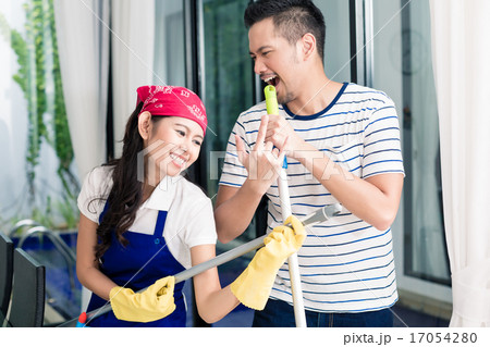 Indonesian couple having fun cleaning the home Indonesian couple having fun cleaning the home 17054280