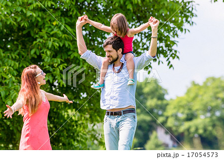 Family walk - Father carrying kid on his shoulder Family walk - Father carrying kid on his shoulder 17054573