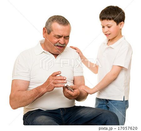 Grandfather and grandchildren playing cards Grandfather and grandchildren playing cards 17057620
