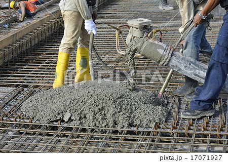 Construction Workers Using Concrete Hose  17071927