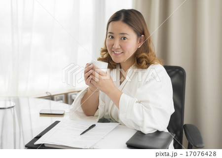Asian woman working in bathrobe Asian woman working in bathrobe 17076428