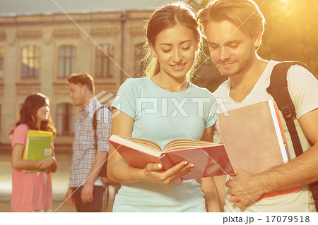 Boy and girl reading book in park 17079518