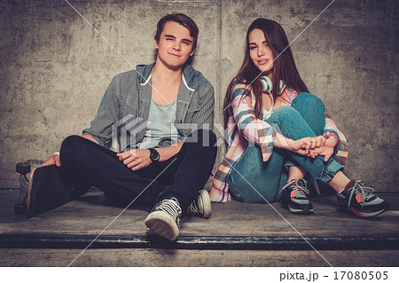Young couple with skateboard outdoors Young couple with skateboard outdoors 17080505