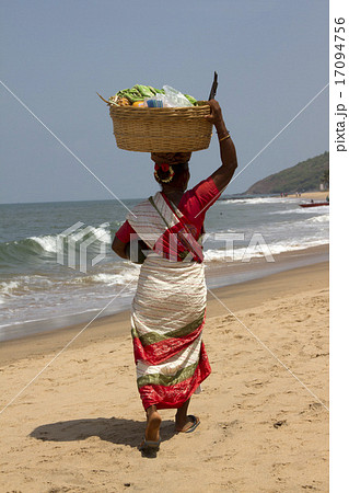 The Indian woman in a sari bears fruit on the head 17094756