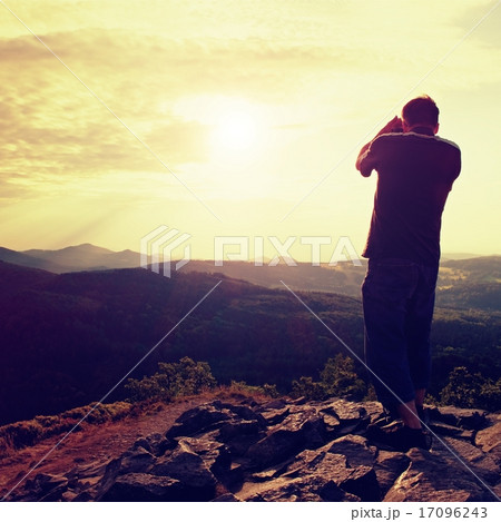 Man takes photos. Dreamy landscape, Sun at horizon Man takes photos. Dreamy landscape, Sun at horizon 17096243