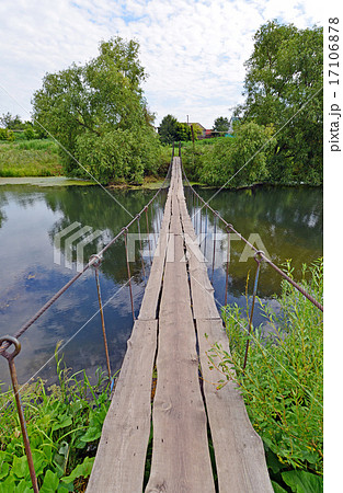 Hanging pedestrian bridge across the river Hanging pedestrian bridge across the river 17106878