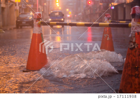 Orange cones around overflowing manhole Orange cones around overflowing manhole 17111938
