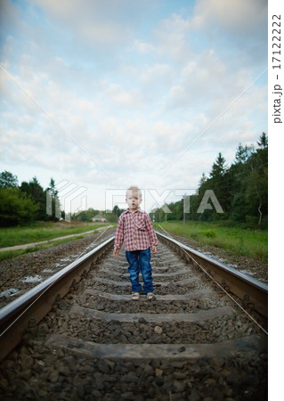 boy playing on the railroad 17122222