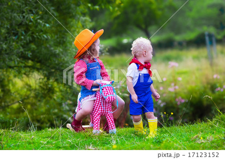Cowboy kids playing with toy horse 17123152