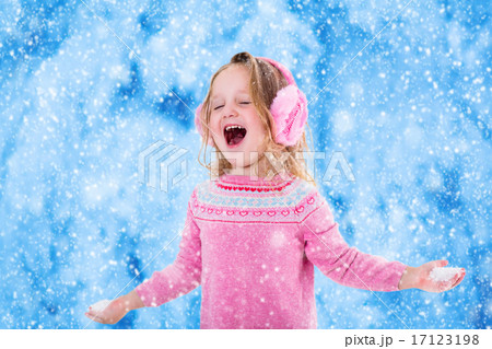 Little girl catching snow flakes 17123198