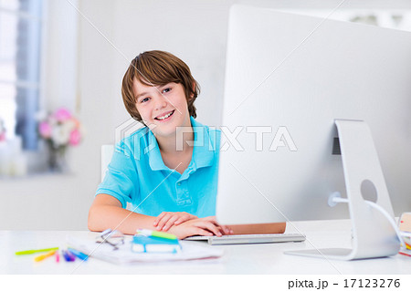 Boy doing homework with modern computer 17123276