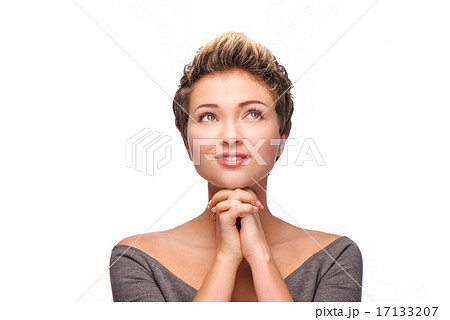 Praying woman with copper-colored hair looking up 17133207