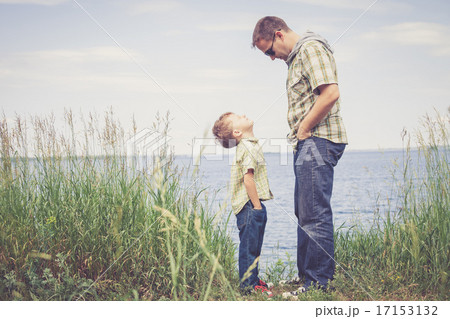 Father and son playing at the park near lake at the day time. 17153132