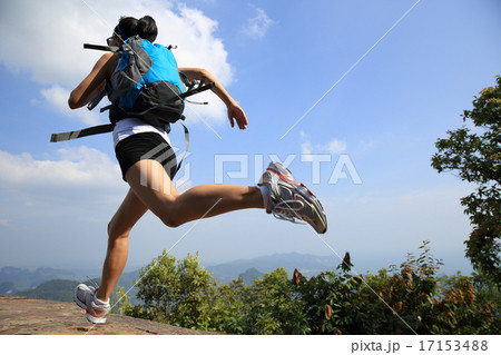 young asian woman hiker running on mountain young asian woman hiker running on mountain 17153488