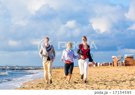 Friends enjoying sunset at ocean beach 17154595