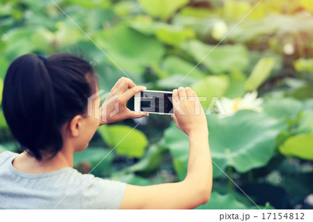 young woman taking photo with smart phone young woman taking photo with smart phone 17154812