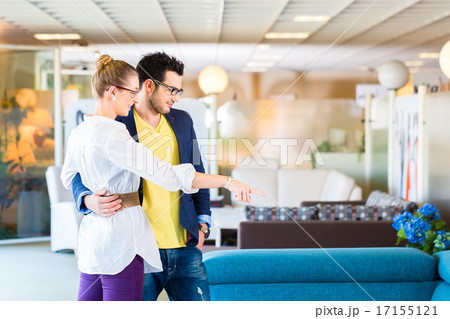Couple buying couch in furniture store Couple buying couch in furniture store 17155121
