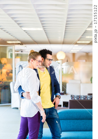 Couple buying couch in furniture store 17155122
