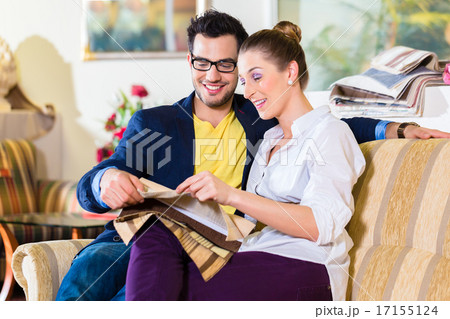 Couple picking couch seat cover in furniture store 17155124