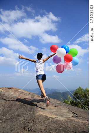 young asian woman running on mountain peak rock young asian woman running on mountain peak rock 17155233