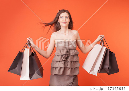 Beautiful young girl with packets is dreaming Beautiful young girl with packets is dreaming 17165053