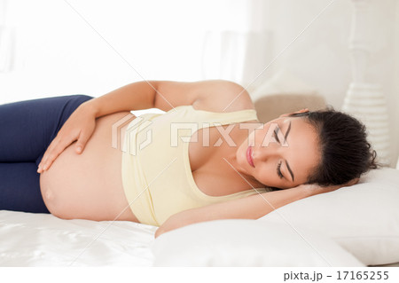 Beautiful young expectant mother is sleeping in bedroom 17165255