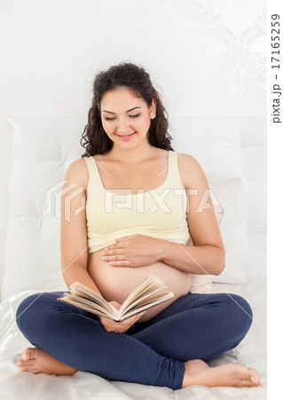 Cheerful young pregnant woman is resting in bedroom 17165259