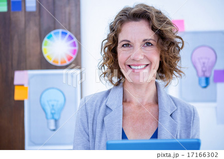 Creative businesswoman using tablet computer Creative businesswoman using tablet computer 17166302
