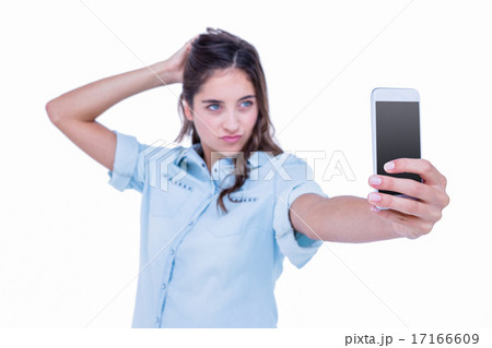 Pretty brunette taking a selfie with smartphone Pretty brunette taking a selfie with smartphone 17166609