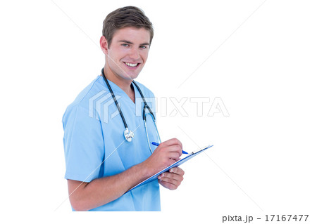 Young nurse in blue tunic writing notes 17167477