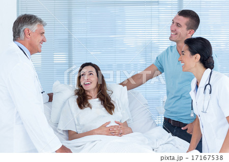 Future parents talking with smiling doctors Future parents talking with smiling doctors 17167538