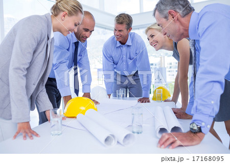Happy team of business people speaking about construction plan 17168095