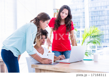 Creative business people using laptop in meeting 17168311
