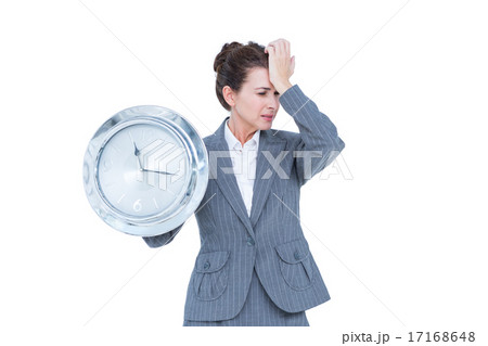 Businesswoman in suit holding a clock 17168648