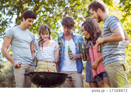 Happy friends in the park having barbecue Happy friends in the park having barbecue 17168672