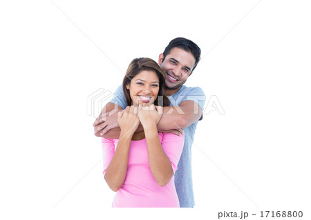 Happy couple embracing and looking at the camera Happy couple embracing and looking at the camera 17168800