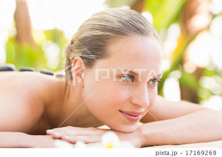 Beautiful woman receiving stone massage at spa center Beautiful woman receiving stone massage at spa center 17169269