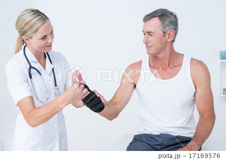 Doctor examining a man wrist Doctor examining a man wrist 17169576