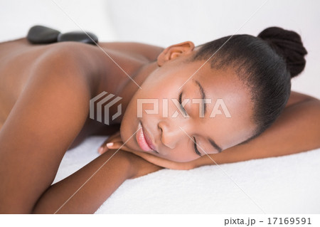 Pretty woman enjoying a hot stone massage Pretty woman enjoying a hot stone massage 17169591
