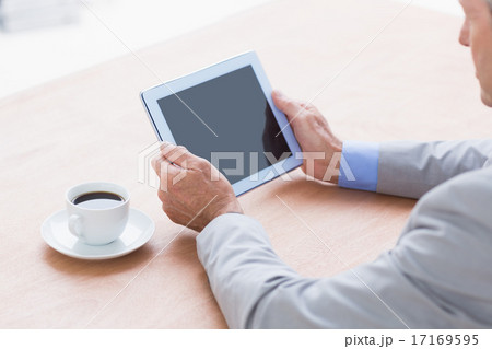 concentrating businessman using a tablet concentrating businessman using a tablet 17169595