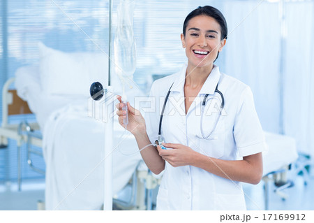 Nurse connecting an intravenous drip Nurse connecting an intravenous drip 17169912