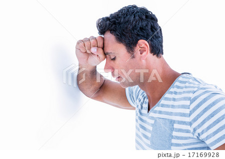 Sad man leaning his head against a wall Sad man leaning his head against a wall 17169928