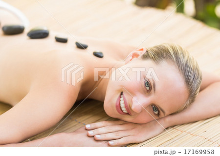 Beautiful woman receiving stone massage at spa center 17169958