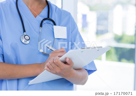 Doctor writing on clipboard Doctor writing on clipboard 17170071
